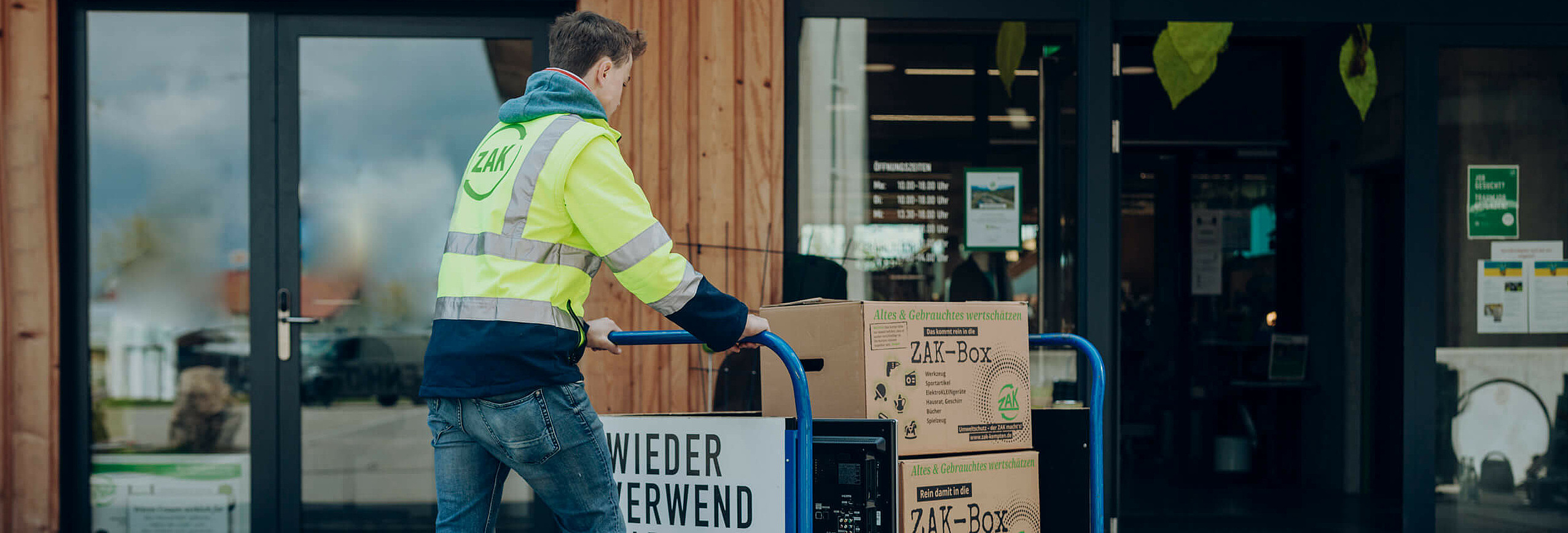 ZAK Mitarbeiter schiebt kleinen Transportwagen ins Lager